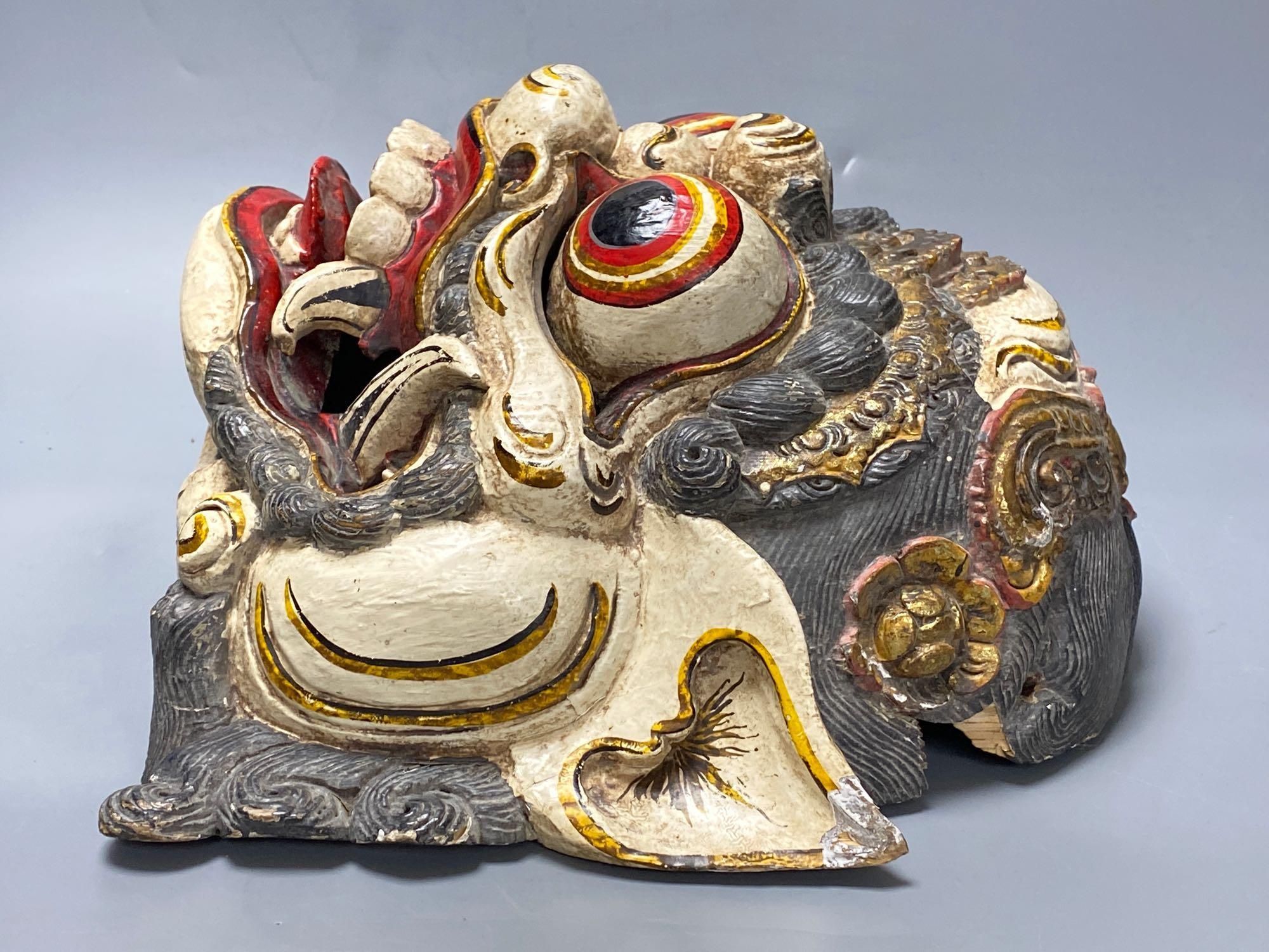 A Balinese carved and painted wood dragon mask, 28cm